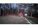 Beautifully landscaped backyard with a charming gazebo, stone pathway, and exterior lighting at 460 Greystone Ln, Douglasville, GA 30134