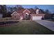 Charming brick home featuring a landscaped front yard and an attached two-car garage at 460 Greystone Ln, Douglasville, GA 30134