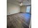 Bedroom with ceiling fan, window, and gray laminate flooring at 596 Windchase Ln, Stone Mountain, GA 30083