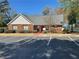 Community clubhouse with red brick, parking, and manicured landscaping at 596 Windchase Ln, Stone Mountain, GA 30083