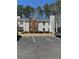 Exterior view of a multi-story townhome with dedicated parking and mature landscaping at 596 Windchase Ln, Stone Mountain, GA 30083