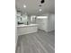 Open-concept kitchen with stylish pendant lighting, quartz countertops and stainless steel appliances at 596 Windchase Ln, Stone Mountain, GA 30083