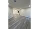 Open-concept living space with gray wood-look flooring and access to the modern kitchen at 596 Windchase Ln, Stone Mountain, GA 30083