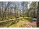 Large lot backyard featuring mature trees, a storage shed, and 2 parked cars at 1490 Highland Lake Dr, Lawrenceville, GA 30045
