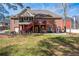 View of the rear exterior of the brick home with screened porch, and ground-level patio at 1490 Highland Lake Dr, Lawrenceville, GA 30045
