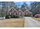Beautiful brick home with a well-manicured lawn and a long driveway leading to the front entrance at 1490 Highland Lake Dr, Lawrenceville, GA 30045
