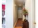 Hallway featuring hardwood flooring, grey walls, and a view of the dining room at 1490 Highland Lake Dr, Lawrenceville, GA 30045