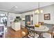 Eat-in kitchen features white cabinets, stainless appliances, and hardwood flooring at 1490 Highland Lake Dr, Lawrenceville, GA 30045