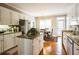 Charming kitchen with white cabinets, granite countertops, stainless appliances, and hardwood flooring at 1490 Highland Lake Dr, Lawrenceville, GA 30045