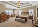 Main bedroom with carpet, trey ceilings, lots of windows and natural light, and a king-size bed at 1490 Highland Lake Dr, Lawrenceville, GA 30045