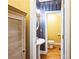 Powder room with striped wallpaper, hardwood flooring, and a pedestal sink at 1490 Highland Lake Dr, Lawrenceville, GA 30045