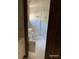 Bathroom featuring a white vanity, commode and a shower behind a glass door at 285 Old College Way, Atlanta, GA 30328