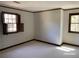 Light-filled room featuring neutral carpet, and two shuttered windows that offer natural light at 285 Old College Way, Atlanta, GA 30328