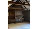 Cozy living room featuring a brick fireplace, exposed beams, and built-in shelving at 285 Old College Way, Atlanta, GA 30328