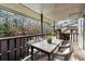 Outdoor balcony overlooking lush greenery, featuring a table with four chairs at 401 Woodcliff Dr, Atlanta, GA 30350