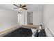 Comfortable bedroom featuring plush carpet, ceiling fan, and ensuite bathroom access at 401 Woodcliff Dr, Atlanta, GA 30350