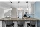 Kitchen with granite countertops, a breakfast bar, and pendant lighting at 401 Woodcliff Dr, Atlanta, GA 30350