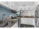 Modern kitchen featuring stainless steel appliances, granite countertops, and ample cabinet space at 401 Woodcliff Dr, Atlanta, GA 30350