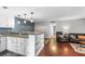 Open-concept kitchen and living space with granite countertops and stainless steel appliances at 401 Woodcliff Dr, Atlanta, GA 30350