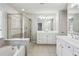 Bright bathroom featuring a tub, a glass shower, double sinks and vanity with granite countertops at 4718 Wehunt Se Trl # 20, Smyrna, GA 30082