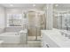 Bright bathroom featuring a tub, a glass shower, double sinks and vanity with granite countertops at 4718 Wehunt Se Trl # 20, Smyrna, GA 30082