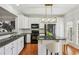 Well-lit kitchen with white cabinets, granite countertops, stainless steel appliances and an eat-in area at 4718 Wehunt Se Trl # 20, Smyrna, GA 30082
