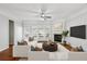 Comfortable living room with white sofas, hardwood floors, fireplace, and a large windows at 4718 Wehunt Se Trl # 20, Smyrna, GA 30082