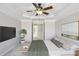 Serene main bedroom featuring a tray ceiling, a fan, a large window, and sitting area at 4718 Wehunt Se Trl # 20, Smyrna, GA 30082