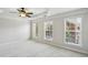 Sun-filled main bedroom featuring neutral walls, plush carpet, and a decorative tray ceiling with fan at 4718 Wehunt Se Trl # 20, Smyrna, GA 30082