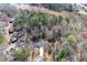 A beautiful wooded property featuring serene lakeside views from an elevated aerial perspective at 6730 Alvan Ct, Riverdale, GA 30296