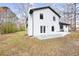 Home's backyard features a concrete patio surrounded by mature trees and natural landscaping at 6730 Alvan Ct, Riverdale, GA 30296