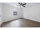 Light-filled bedroom with a modern ceiling fan and large window at 6730 Alvan Ct, Riverdale, GA 30296