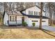 Charming two-story home featuring a covered porch, a two-car garage, and a well-manicured lawn at 6730 Alvan Ct, Riverdale, GA 30296