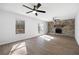 Open-concept living room with stone fireplace and access to the backyard through glass doors at 6730 Alvan Ct, Riverdale, GA 30296