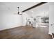 Open-concept living area with hardwood floors, and a beamed ceiling adjoining a modern kitchen at 6730 Alvan Ct, Riverdale, GA 30296