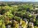 Aerial view of a neighborhood showcasing lush greenery, mature trees, and sprawling homes at 1544 Blue Bird Way, Cumming, GA 30041