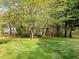 Charming backyard featuring a classic wooden swing set nestled among mature trees at 1544 Blue Bird Way, Cumming, GA 30041