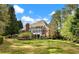 Beautiful backyard featuring mature trees, lush landscaping, a patio, and a manicured lawn at 1544 Blue Bird Way, Cumming, GA 30041