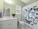 Bright bathroom with a white vanity, toilet, and shower featuring a charming butterfly-themed shower curtain at 1544 Blue Bird Way, Cumming, GA 30041