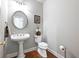Elegant powder room featuring a pedestal sink and stylish decor at 1544 Blue Bird Way, Cumming, GA 30041