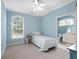 Cozy bedroom featuring carpet, light blue walls, and an ensuite bathroom at 1544 Blue Bird Way, Cumming, GA 30041