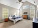 Bright bedroom features vaulted ceilings, many windows, neutral tones, and a comfortable bed with stylish linens at 1544 Blue Bird Way, Cumming, GA 30041