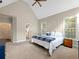 Spacious bedroom with neutral carpet and paint, vaulted ceilings and ensuite bath access at 1544 Blue Bird Way, Cumming, GA 30041