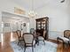 Well-lit dining room showcases hardwood floors, chandelier, and access to living area at 1544 Blue Bird Way, Cumming, GA 30041