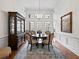 Formal dining room featuring elegant chandelier, hardwood floors, and large windows at 1544 Blue Bird Way, Cumming, GA 30041