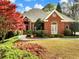 Charming brick home with manicured lawn, mature landscaping, and classic architectural details at 1544 Blue Bird Way, Cumming, GA 30041