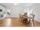 Eat-in kitchen featuring wood floors, white cabinets, and stainless steel appliances at 1544 Blue Bird Way, Cumming, GA 30041