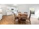 Eat-in kitchen boasting wood floors, white cabinetry, and modern appliances at 1544 Blue Bird Way, Cumming, GA 30041