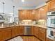 Lovely kitchen area showcasing wooden cabinetry, stainless steel appliances, and hardwood floors at 1544 Blue Bird Way, Cumming, GA 30041