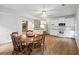 Bright eat-in kitchen featuring white cabinets, wood floors, and stainless steel appliances at 1544 Blue Bird Way, Cumming, GA 30041